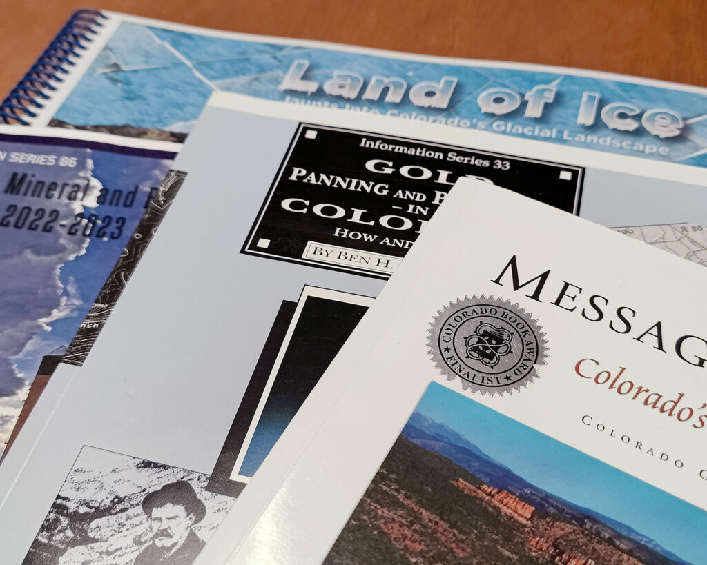 Close-up on four soft-cover publications spread out on a table. Spread of recent hard copies of CGS publications. Photo credit: Matt Morgan (CGS).