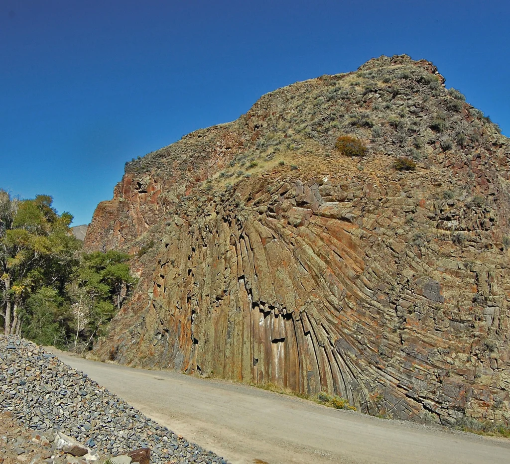 Igneous rock outcrop with linear, radial pattern. Columnar jointing in igneous rocks, Moffat County (October, 2026 CGS Geology Calendar). Photo credit: Larry Scott (CGS).