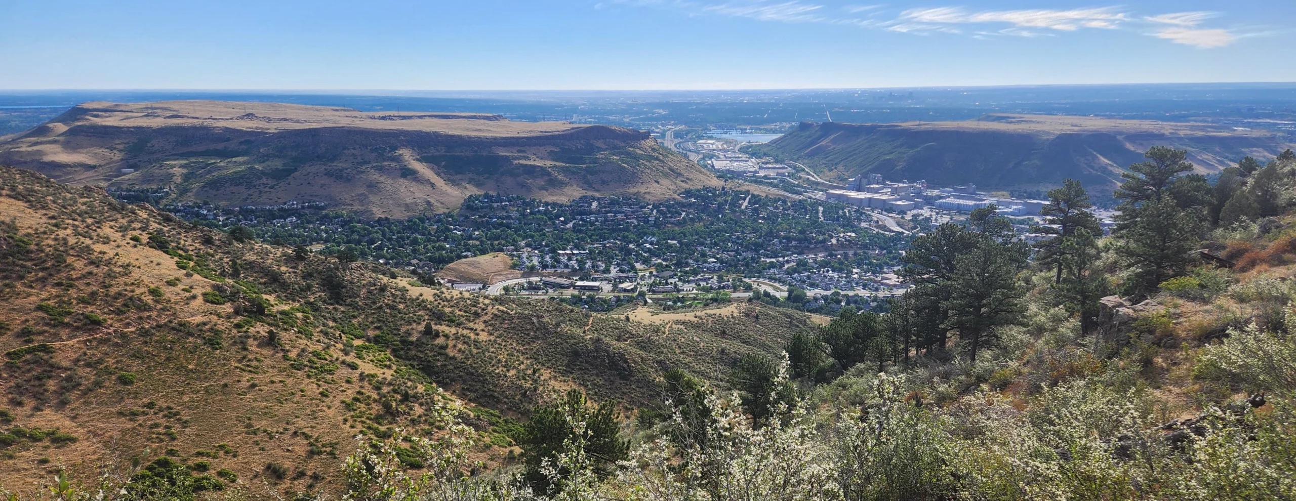 view of two flat topped mountains, with a town in between