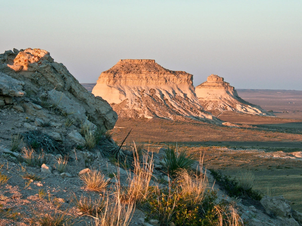 Pawnee Buttes in the Pawnee National Grasslands are capped with a cemented sand-silt-conglomerate from the Miocene Ogallala Group underlain with tuffaceous sandy silts from the Eocene-Oligocene White River Formation. Photo credit: Colorado Geological Survey.