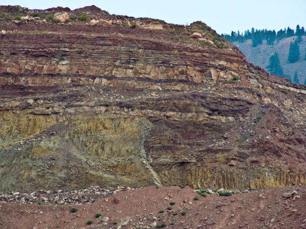 Paleogene andesite sill in a quarry southwest of Lyons. The sill intrudes the upper Paleozoic Fountain Formation. Note the vertical columnar jointing in the sill. Primary use of andesite in this sill is for commercial aggregate. Photo credit: Vince Matthews for the CGS.
