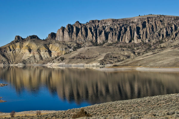 The erosional towers on Blue Mesa Reservoir are carved in the West Elk Breccia which is exposed in numerous places around Gunnison on Highway 50. These breccias are a feature of a large stratovolcano whose vent is about 15 miles north of the reservoir in the West Elk Mountains. Photo credit: Vince Matthews for the CGS.