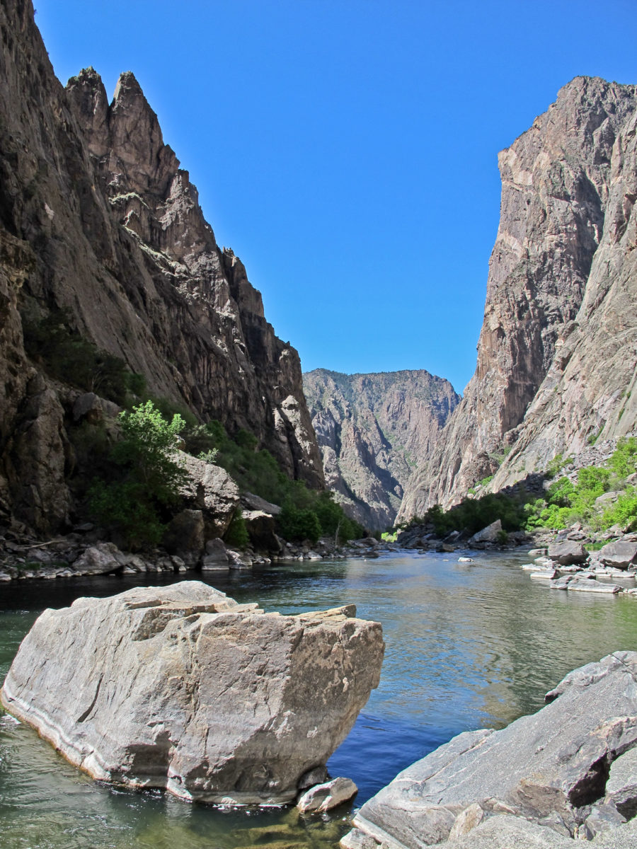 Incised up to 2700 ft (800 m) through 1.8 billion-year-old Precambrian granites, gneisses, gabbros, diorites, pegmatites, and schists, the Black Canyon of the Gunnison (River) in south-western Colorado is one of the most dramatic river settings in the world. Photo credit: Colorado Geological Survey