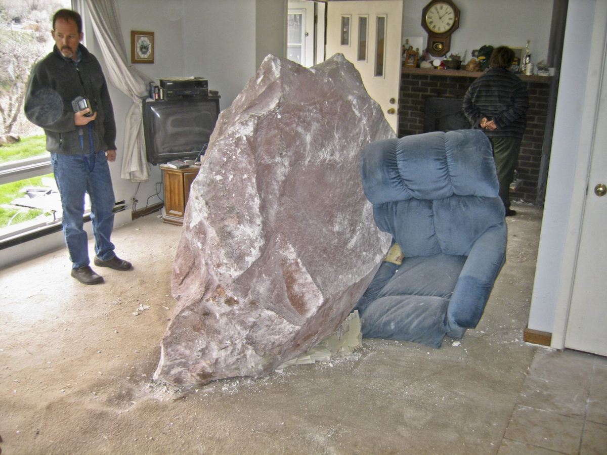 Several large rocks from the western wall of the Roaring Fork River in Glenwood Springs crashed into the houses below during the early morning causing significant damage, April 2004. Photo credit: Steve Vanderleest, used by permission.