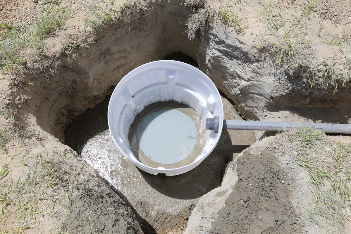 The finished level subsurface platform of sand-blasted glass on concrete inside plastic seismometer housing, Briggsdale, Colorado, May 2016. Photo credit: Mike Bornowski for the CGS.