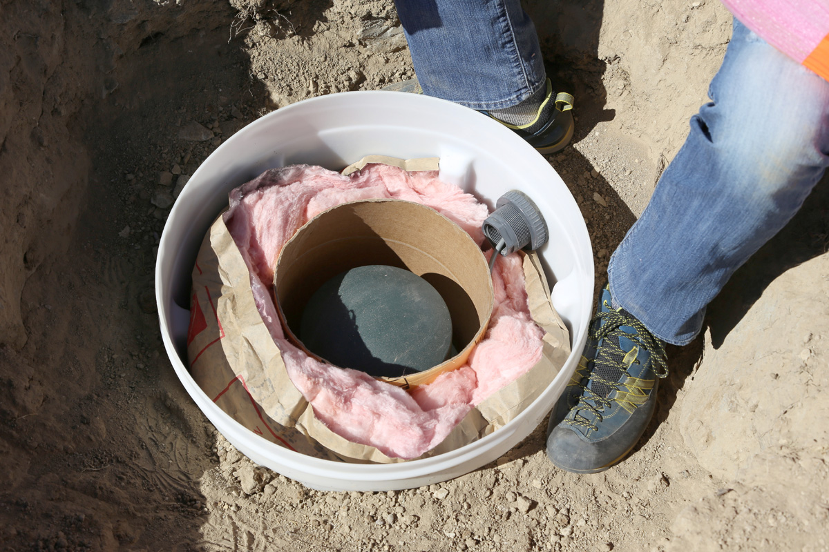 Adding insulation to the Trimble Ref-Tek 151-30 Broadband Seismometer in subsurface housing, Briggsdale, Colorado, May 2016. Photo credit: Mike Bornowski for the CGS.