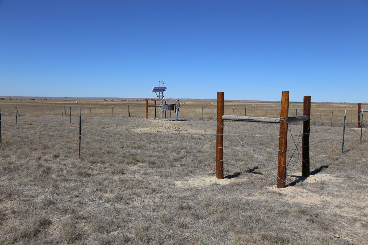 Complete PV power and data transmission tower with control box, inside cattle-proof fencing, Briggsdale, Colorado, May 2016. Photo credit: Mike Bornowski for the CGS.