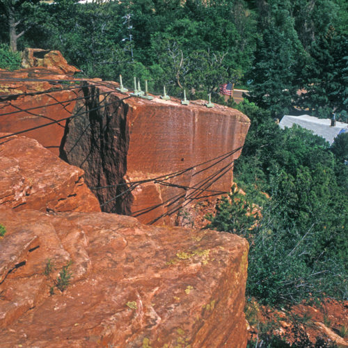 A precarious rock above Manitou Springs started to move in 1995 after a period of wet weather. As an emergency measure, high-strength steel cables were wrapped around the rock and anchored to the surrounding ledge to arrest the movement. Photo credit Jon White for the CGS.