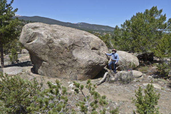 Glacial flood boulder in the Arkansas River Valley above Buena Vista, Colorado. Emeritus USGS geologist, Karl Kellog for scale. Photo credit: Keenan Lee for the CGS.