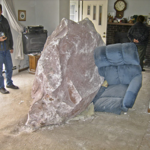 Figure 2 -- Several large rocks from the western wall of the Roaring Fork River in Glenwood Springs crashed into the houses below during the early morning causing significant damage, April 2004. Photo credit: Steve Vanderleest, used by permission.