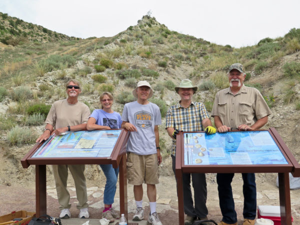 Trail maintenance volunteers on the Hogbacks Open Space Interpretive Trail with signs explaining the Western Interior Seaway and index fossils. Photo credit: Cindy Smith.