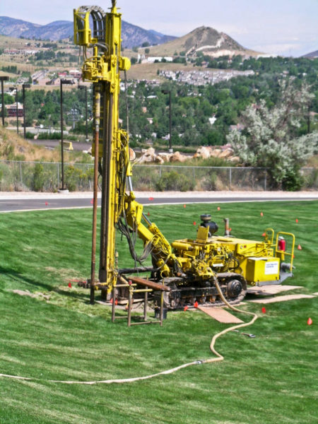 A drill-rig preparing boreholes for subsurface grouting under the IM field in August 2005. Photo credit: T. C. Wait for the CGS.