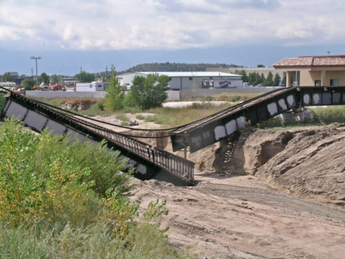 Flooding and erosive flows following a 2004 rainstorm caused this bridge collapse in El Paso County. East Sand Creek had been 